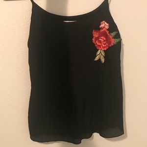 Black top with floral embellishment